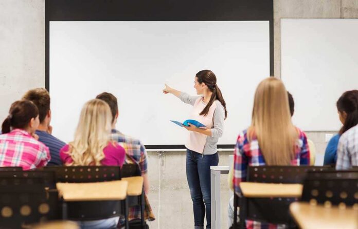 A teacher presenting to students in a classroom