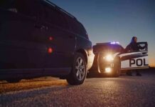 An LA Street Has Become an Open-Air Marketplace Police officer at patrol car during traffic stop at dusk