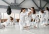 martial arts students practicing grappling in a dojo