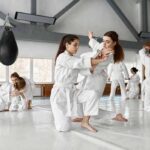 martial arts students practicing grappling in a dojo