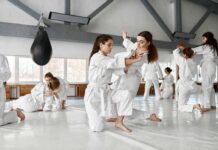 martial arts students practicing grappling in a dojo