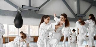 martial arts students practicing grappling in a dojo