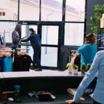 Clothing store interior with staff near entrance during tense incident