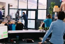 Clothing store interior with staff near entrance during tense incident