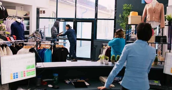 Clothing store interior with staff near entrance during tense incident