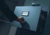 Hand opening a filing cabinet drawer labeled top secret